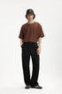 Model in black mens dress pants with brown oversized T-shirt