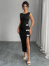 Woman wearing a black slit dress with white bow details against a gray background