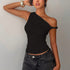 Woman wearing a black one-shoulder top and gray jeans against a plain background