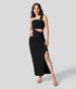 Black maxi dress with one-shoulder neckline, waist cut-out, and front slit in elegant standing pose.