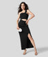 Black one-shoulder dress with curved waist cut-out and thigh slit captured in angled front view.
