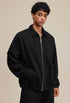 Black polo zip up, three-quarter pose, relaxed fit