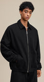 Black polo zip up, three-quarter pose, relaxed fit