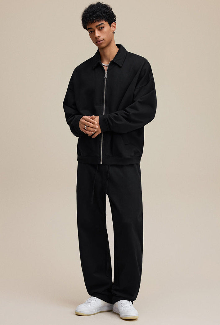 Model in black polo collared zip sweatshirt, full front