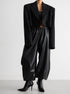 Black PU leather women’s pants styled with cropped blazer