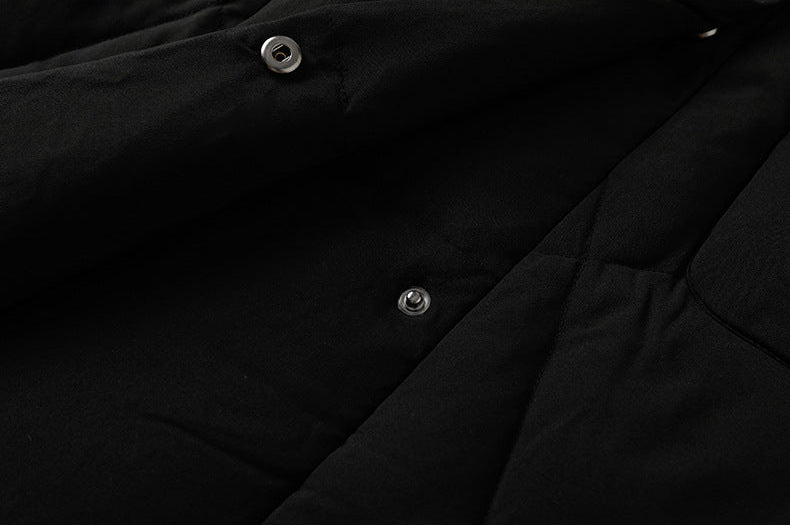 Hidden snap button detail on black down puffer coat