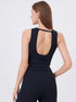 Angled back view of woman wearing black scoop-back workout tank top and high-rise leggings.