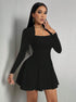 Black square-neck long sleeve mini dress with fitted top and flared A-line skirt in front view.