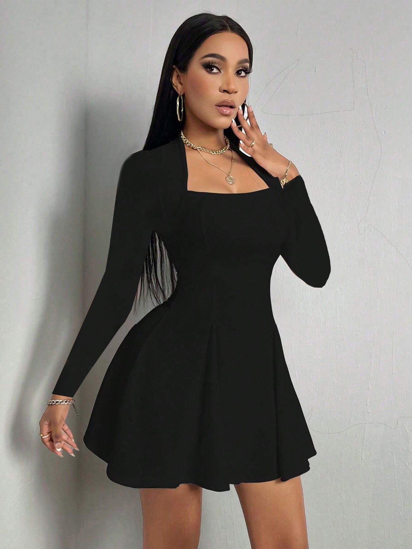 Black square-neck long sleeve mini dress with fitted top and flared A-line skirt in front view.