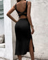 Back view of black square-neck bodycon midi dress featuring strappy back and side slit.