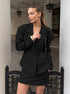 Woman wearing black tailored blazer with structured shoulders