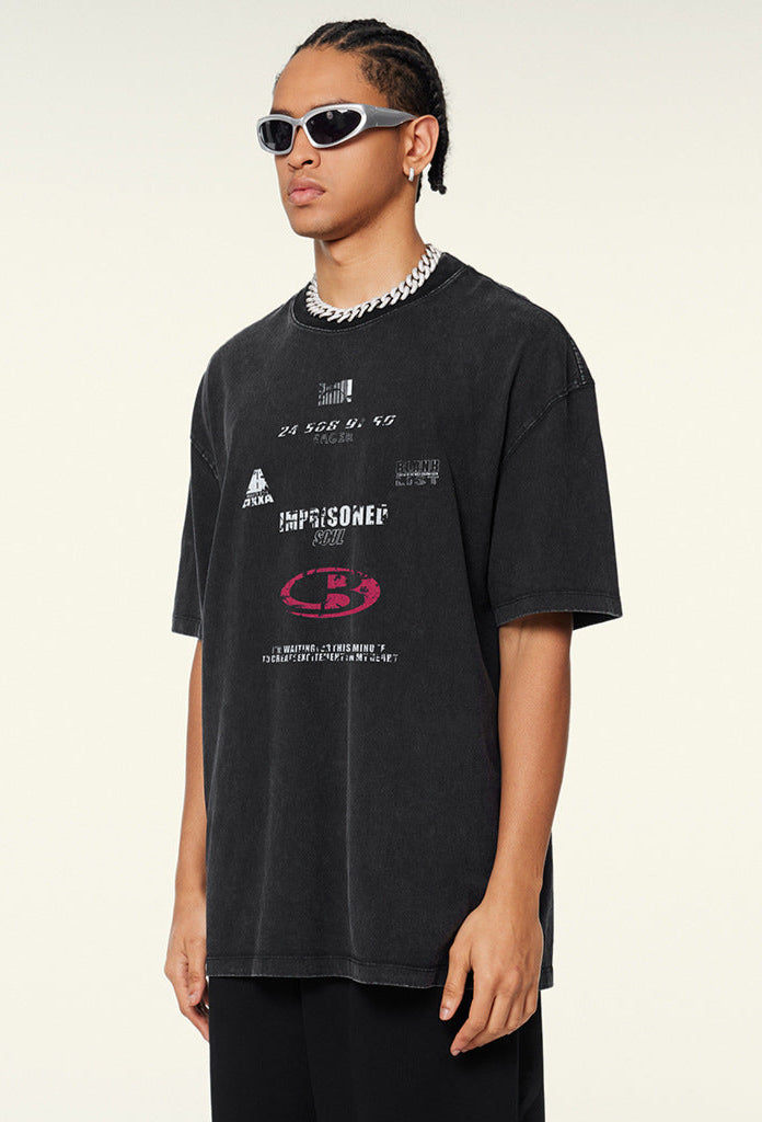 Model in side angle wearing black washed tee with bold red logo