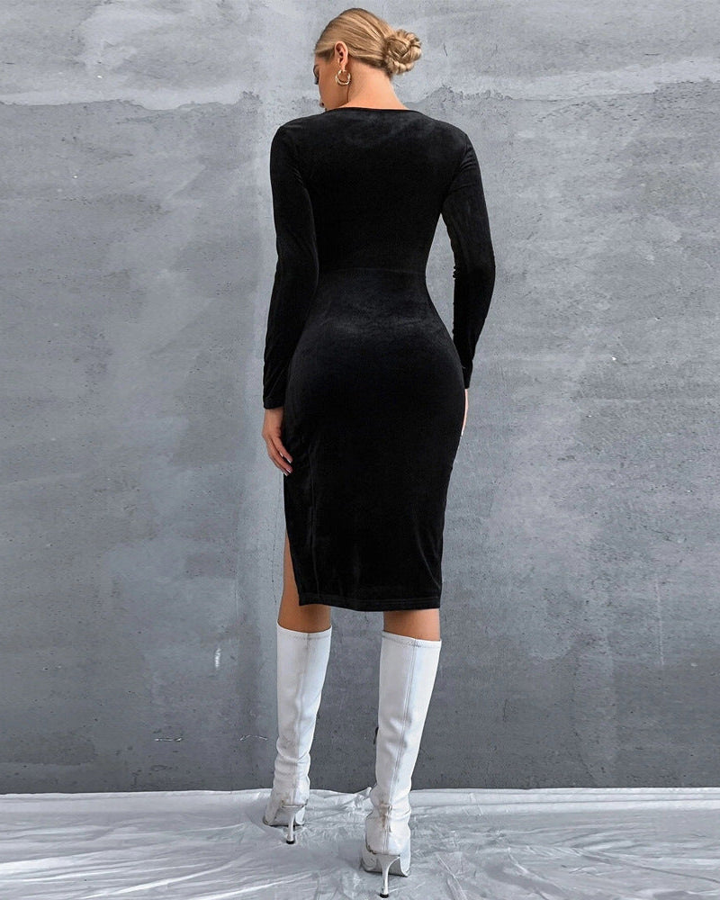 Back view of black velvet bodycon dress with long sleeves and fitted midi silhouette.