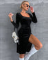 Black velvet bodycon dress with long sleeves and dramatic side slit shown in side-angle standing view.