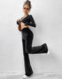 black velvet flare pants full body casual pose