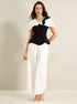 full body front view of black cape top and white trouser suit