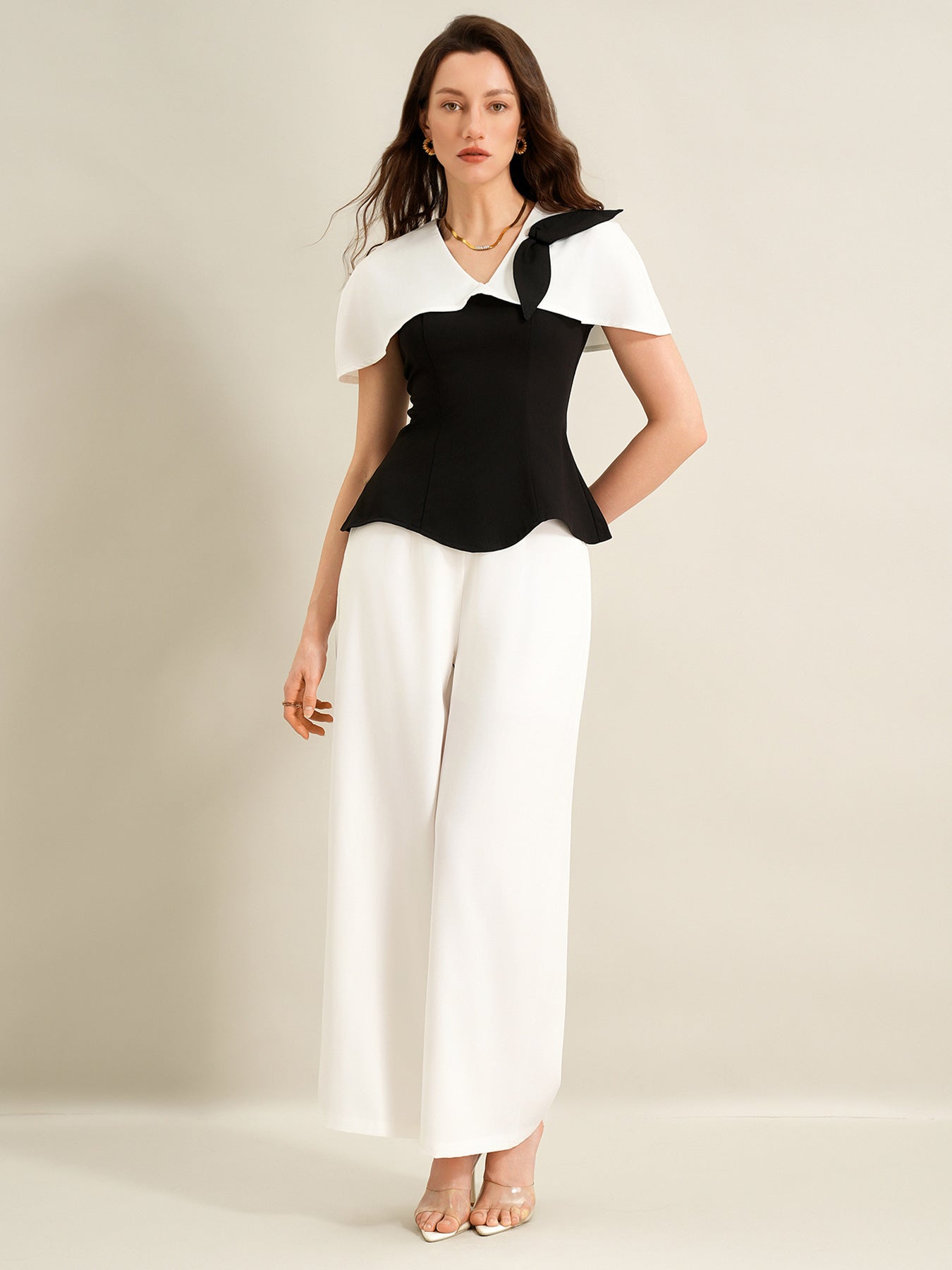 full body front view of black cape top and white trouser suit