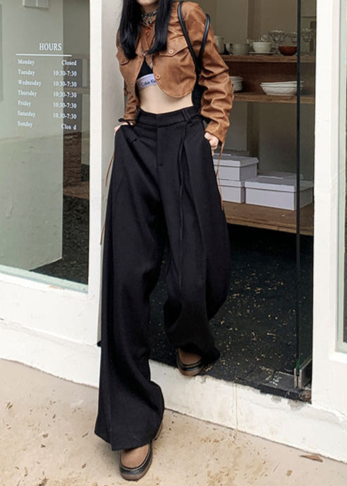 Black wide-leg trousers with drawstring, styled with brown cropped jacket and beret.