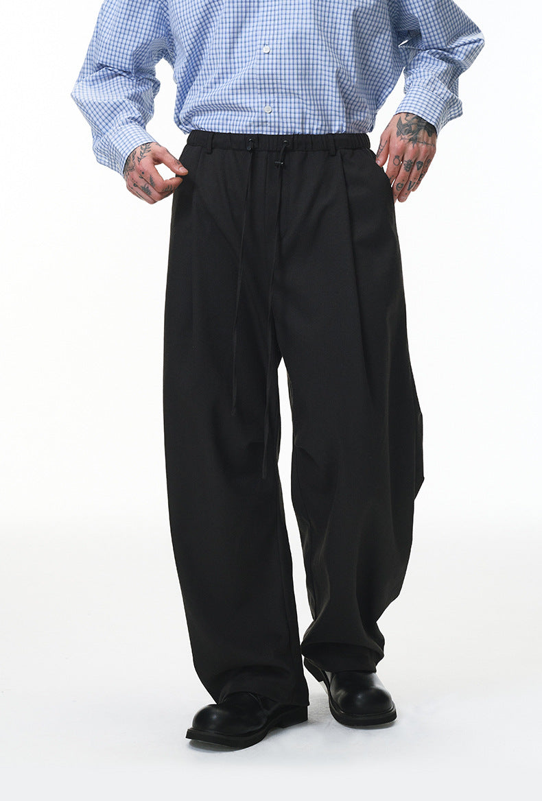 Black wide-leg trousers with elastic drawstring waist, loose streetwear style