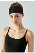 Front view of woman wearing black workout headband.