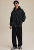 Model full outfit in black zip hoodie and pants, oversized fit