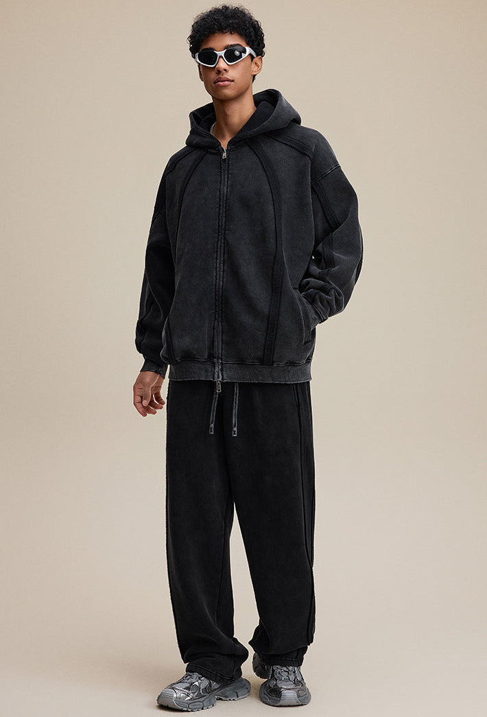 Model full outfit in black zip hoodie and pants, oversized fit