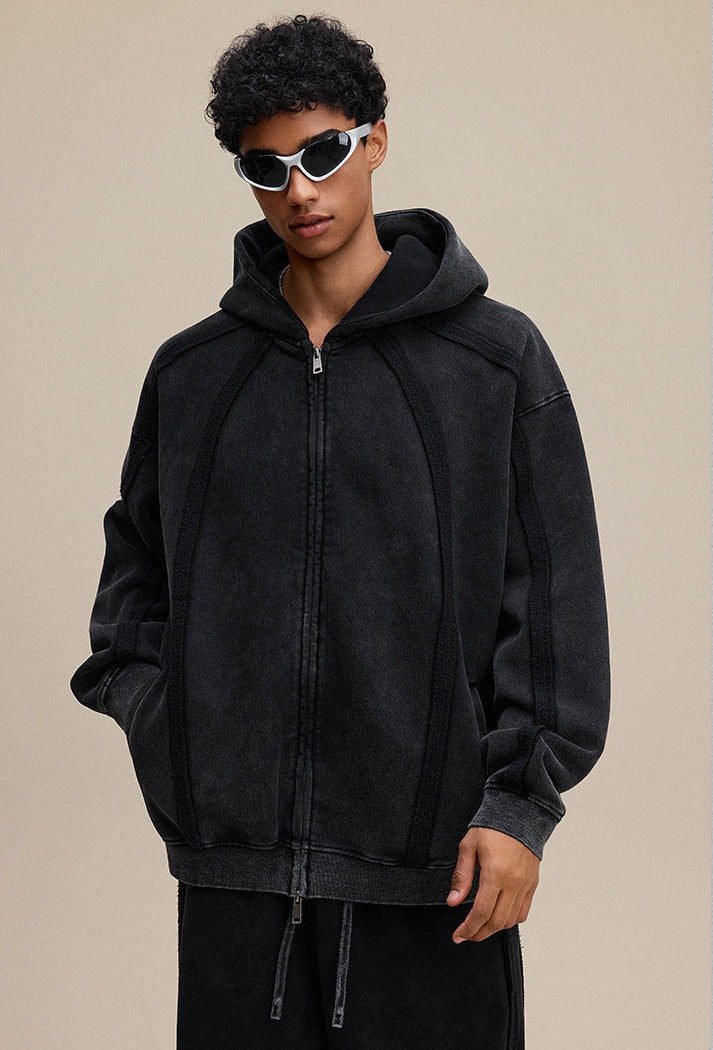 Front close view of black zip hoodie showing sculpted panel seams