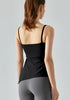 Back view of woman in black yoga tank top and gray leggings.