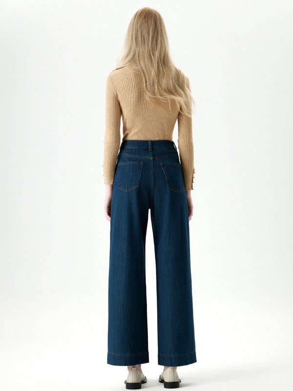 Back view of high rise straight leg denim jeans styled with neutral top.