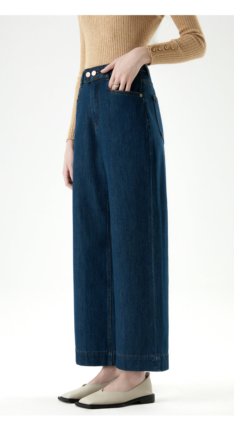 Close-up of blue wide leg jeans with cuffed hem and side pocket detail.