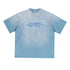 Blue oversized tee with motivational quote in dark blue, displayed on textured background.