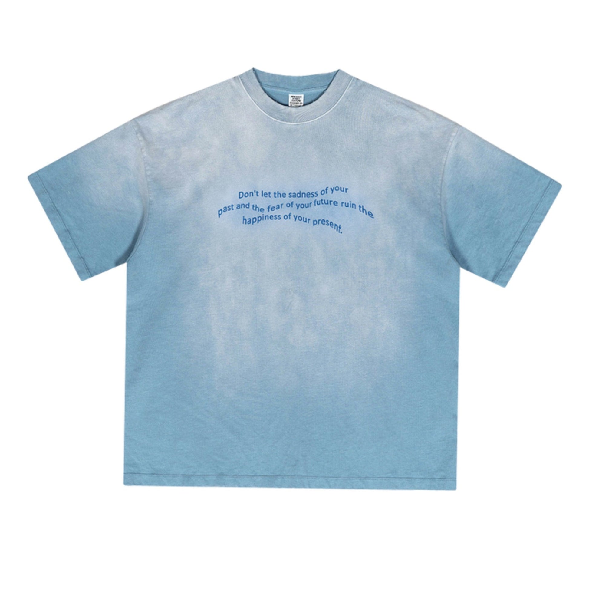 Blue oversized tee with motivational quote in dark blue, displayed on textured background.