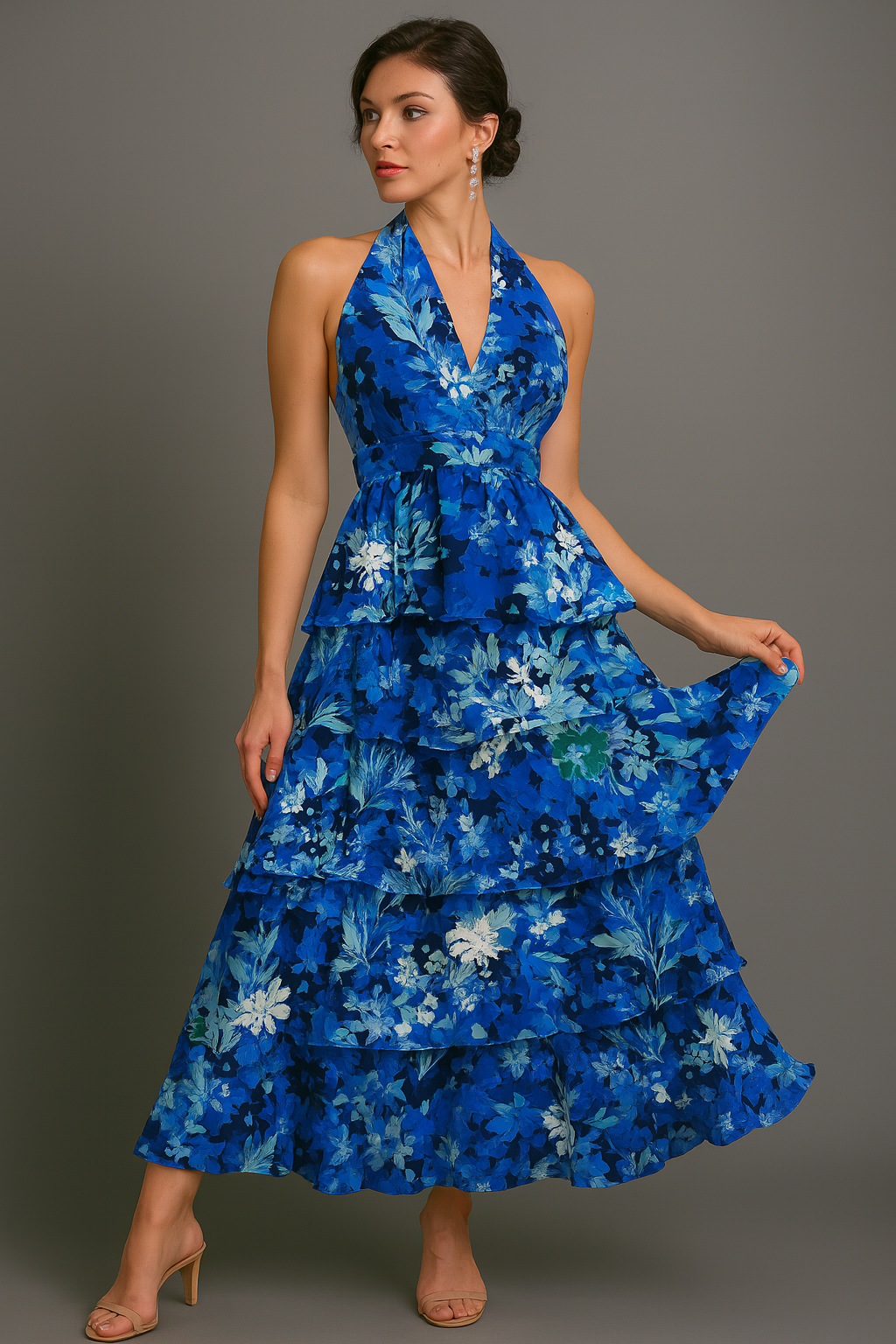 Woman wearing a blue halter floral dress against a gray background