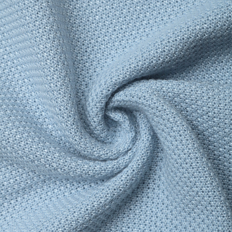 Close-up of soft blue knit fabric in spiral, showing texture and weave.