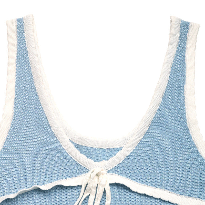Flat lay of blue knit tank top with lace trim and front bow, showing neckline and strap details.