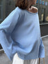 Woman wearing light blue knit sweater with relaxed fit