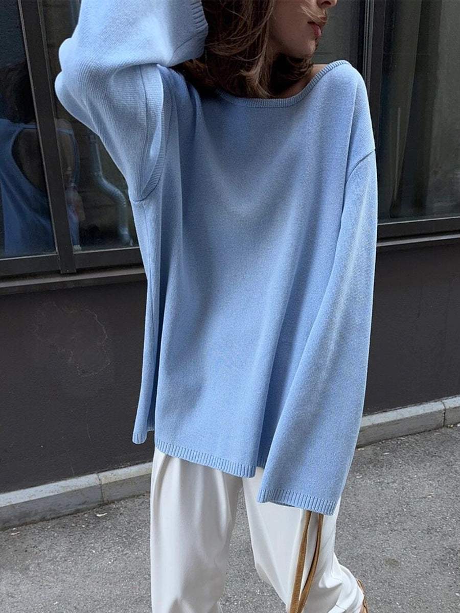 Side view of woman in light blue knit sweater outdoors