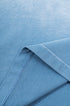 Close-up of inside seam and hem stitching on blue gradient tee fabric.