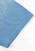 Close-up of blue tee sleeve hem with visible stitching on flat surface.