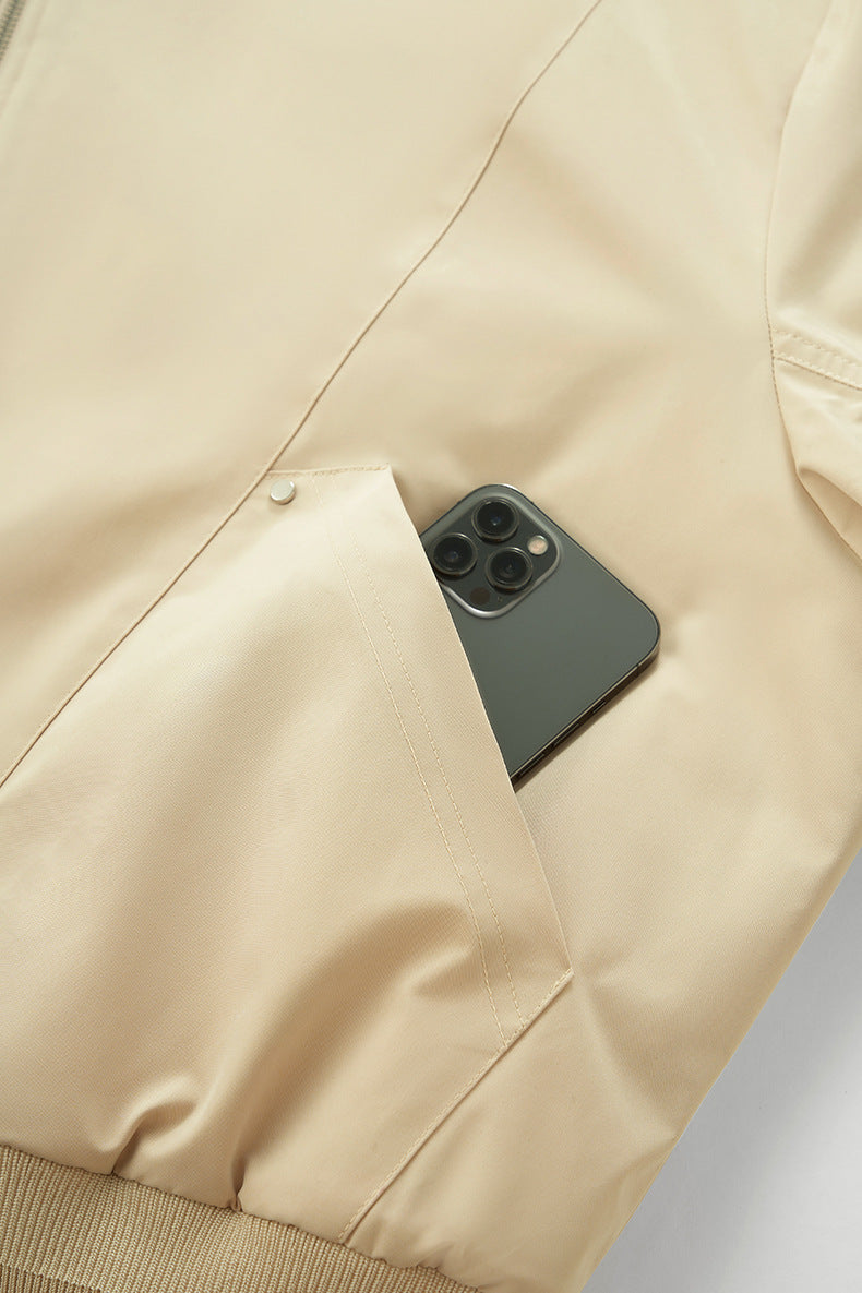 Beige bomber pocket with phone, hidden snap pocket detail