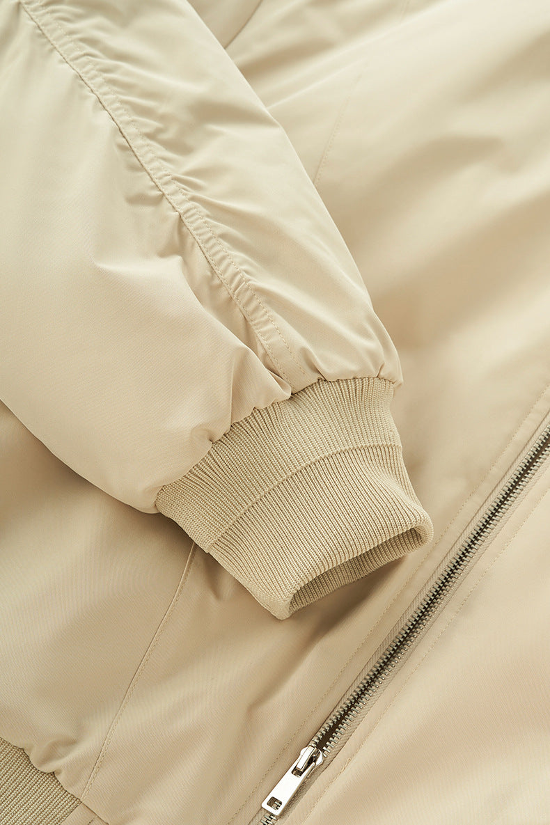 Beige bomber sleeve and rib cuff close-up, zip tape detail