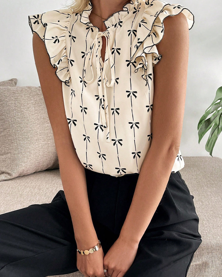 Bow print short sleeve blouse with ruffle sleeves women’s casual top sitting view