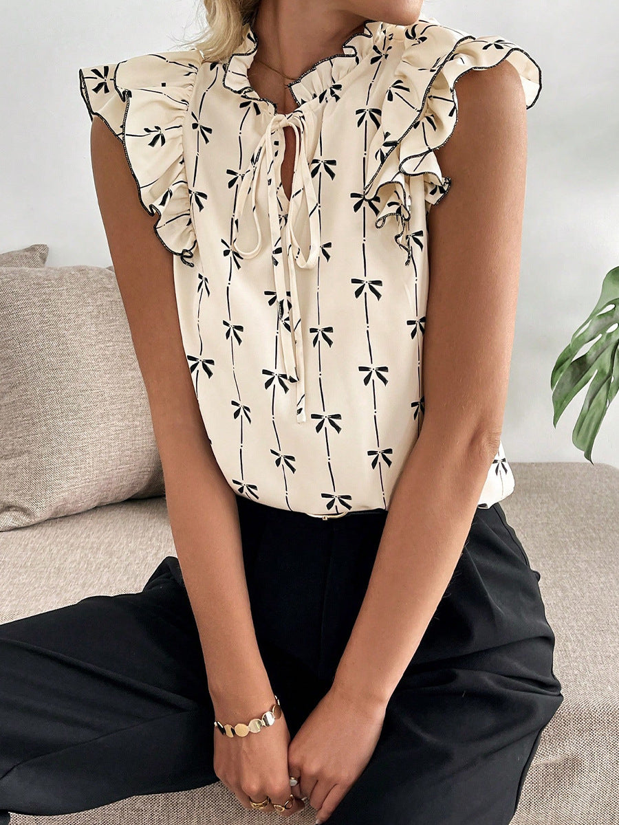 Bow print short sleeve blouse with ruffle sleeves women’s casual top sitting view