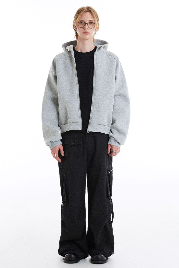 Light gray boxy cropped zip-up hoodie styled open with wide black cargo pants