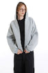 Light gray cropped hoodie worn with the hood up, showing the full front zipper
