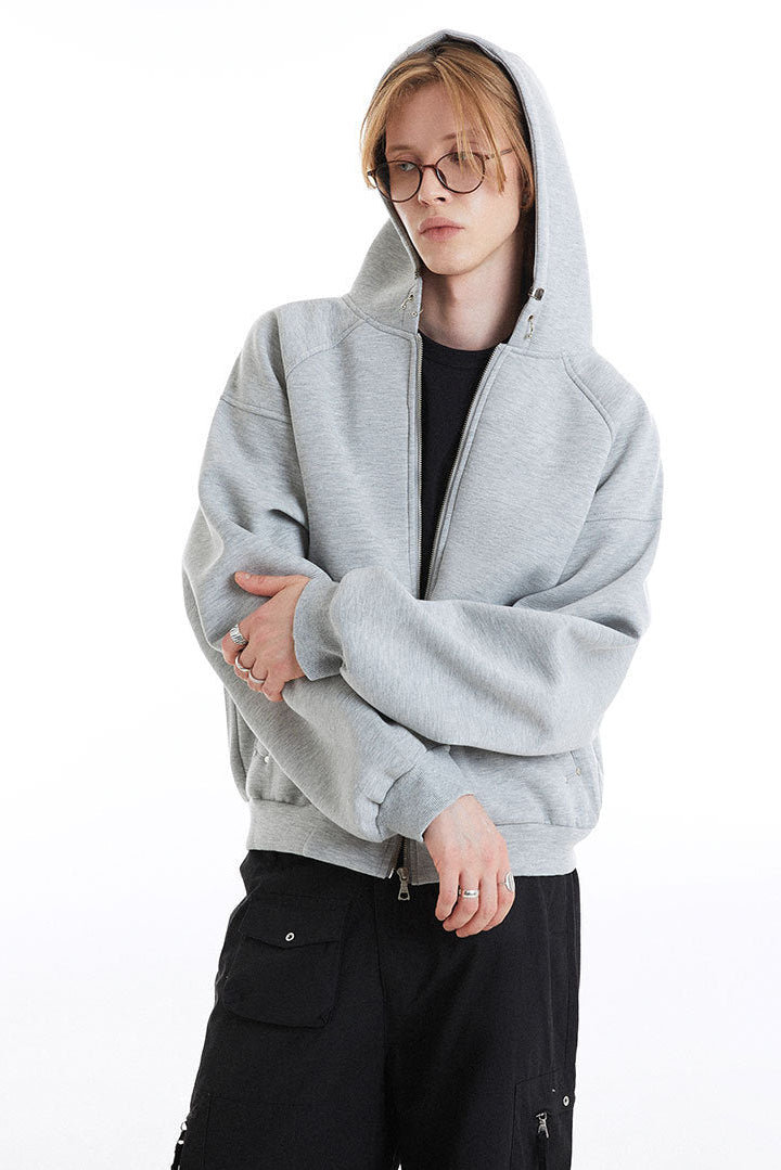 Close view of the light gray boxy hoodie with raglan seams and long sleeves