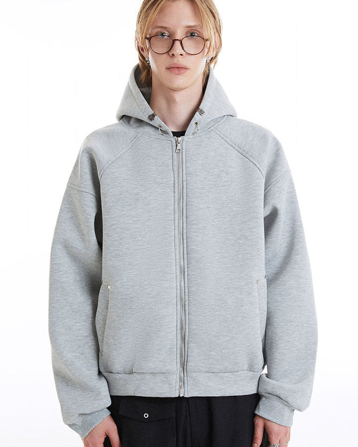 Front view of the light gray zip-up hoodie showing the structured hood and welt pockets