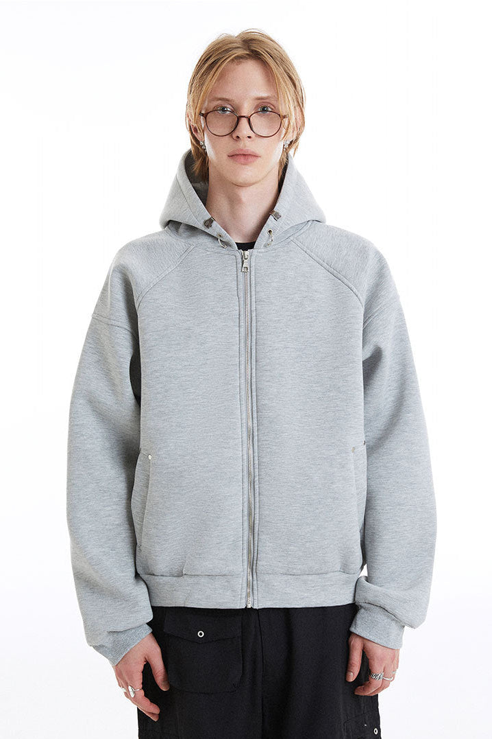 Front view of the light gray zip-up hoodie showing the structured hood and welt pockets