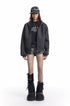 Charcoal cropped zip-up hoodie styled open with a black graphic tee and shorts
