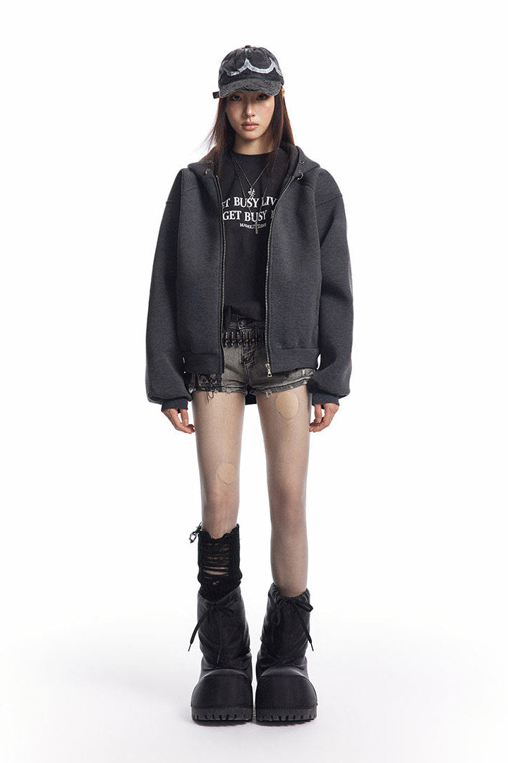 Charcoal cropped zip-up hoodie styled open with a black graphic tee and shorts